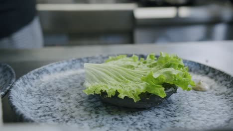 A-professional-chef-is-preparing-a-hamburger-in-his-kitchen---01