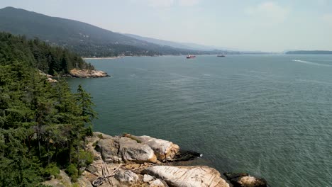 Aerial-descent-of-coastline-Lighthouse-park,-North-Vancouver,-Canada