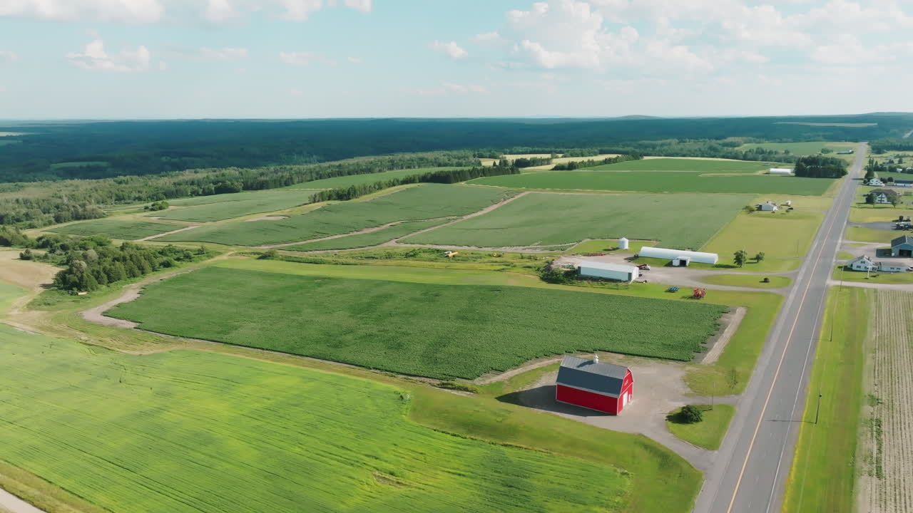 Drone View of Maine Countryside with Classic Red Barn and Adjacent Road