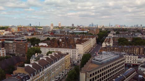 aerial video of london in the early morning taken from south kensington with skyscrapers and famous landmarks in the background and moving traffic in the foreground