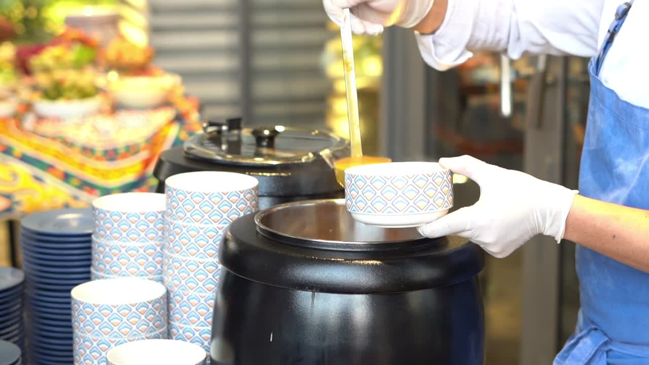 A Chief cooks soup on an oven, close up shot, insert shot