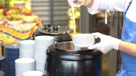 a chief cooks soup on an oven, close up shot, insert shot