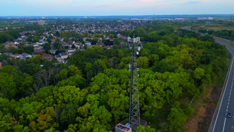 orbital aerial view of cell phone tower close to neighbourhood