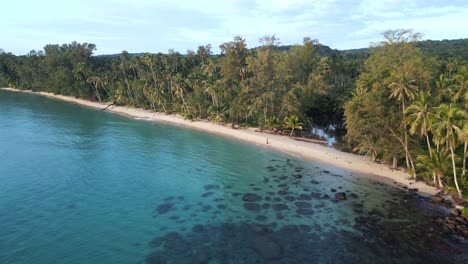 Woman-walking-lonely-and-alone-untouched-natural-beach-with-jungle