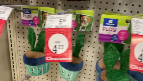 dog toys squeaky stuffed animals hanging on shelves in pet store for puppies and playful dogs and pets