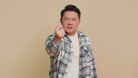 angry aggressive asian man showing fig negative gesture refusal fig sign rapacious avaricious