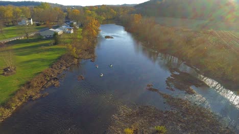 Static-aerial-of-three-kayaks-on-Elkhorn-Creek-paddling-downstream-in-fall