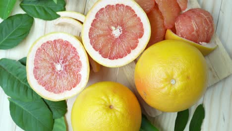 fresh grapefruit with leaves on wooden background, top view rotate grapefruit or pomelo on wooden background, 4k resolution.