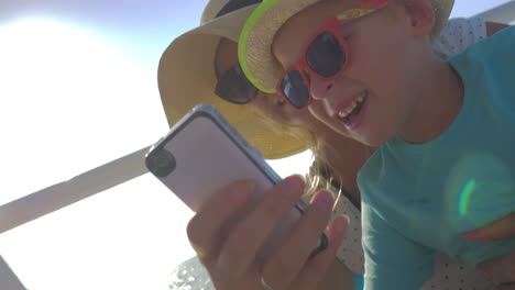 Mom-and-son-taking-funny-selfie-on-the-yacht