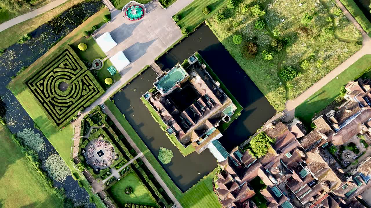 Soar above Hever Castle, a birds eye view capturing its beautiful moated grounds and surrounding buildings. Perfect for heritage, cinematic, and travel videos.