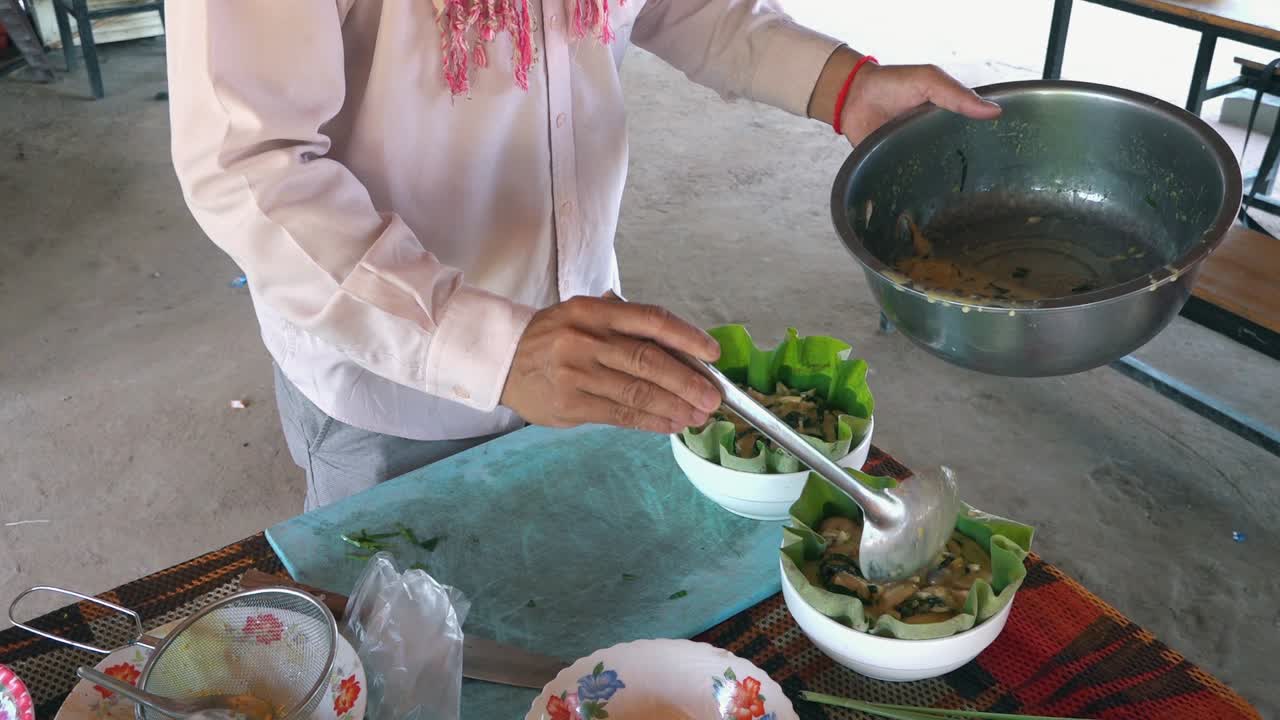 Slow Motion Shot of Fish Amok Being Ladeled into Banana Leaves at a Khmer Cooking Class in Cambodia