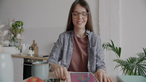 woman having a video call in her kitchen