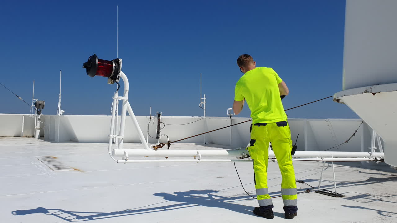 Navigation officer carrying out routine maintenance of navigational equipment