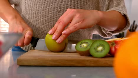 close up of a woman cutting apple