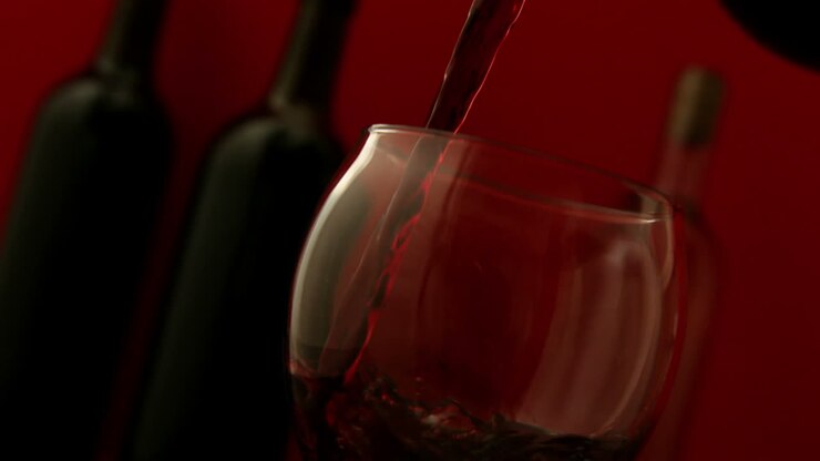 Red wine pouring into wine glass