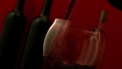 red wine pouring into wine glass