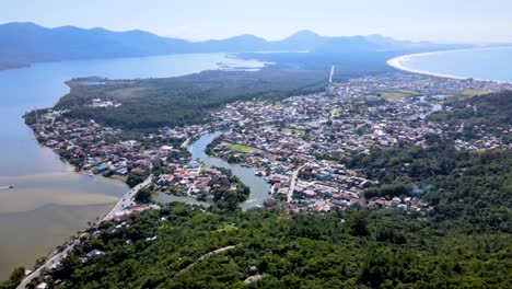 aerial drone scene of city between ocean and river tropical urbanism