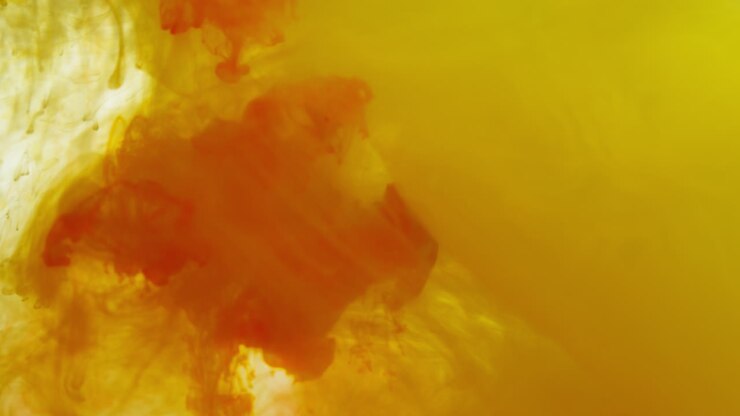 Yellow And Orange Paint Or Dye Dropped Into Water Against White Background To Create Swirling Colourful Smoke Background 6