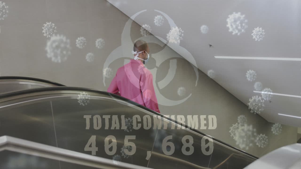 Biohazard symbol with increasing cases against african american senior manusing escalator