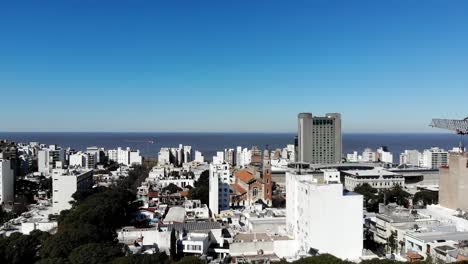 aerial view of the city montevideo uruguay, with buildings, a construction crane, the sea and the clear sky in the background