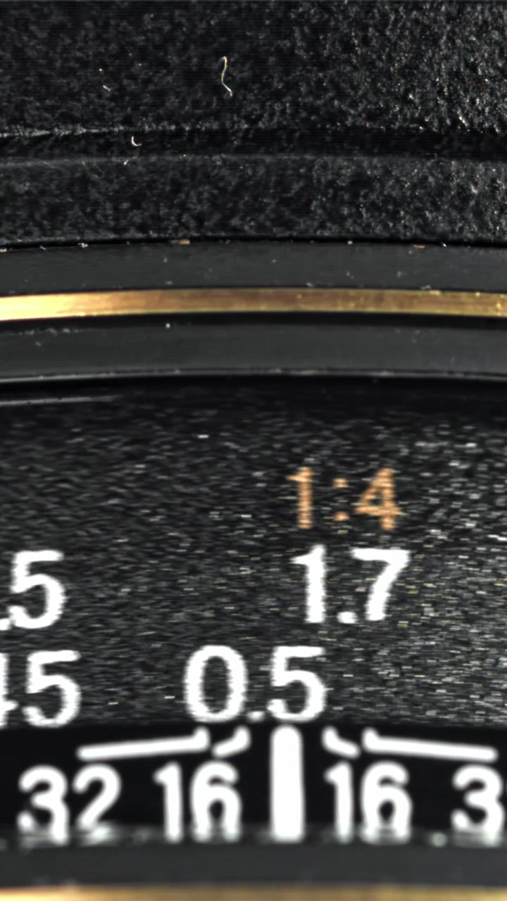 Close-up View of a Camera Lens Focus Ring Being Adjusted