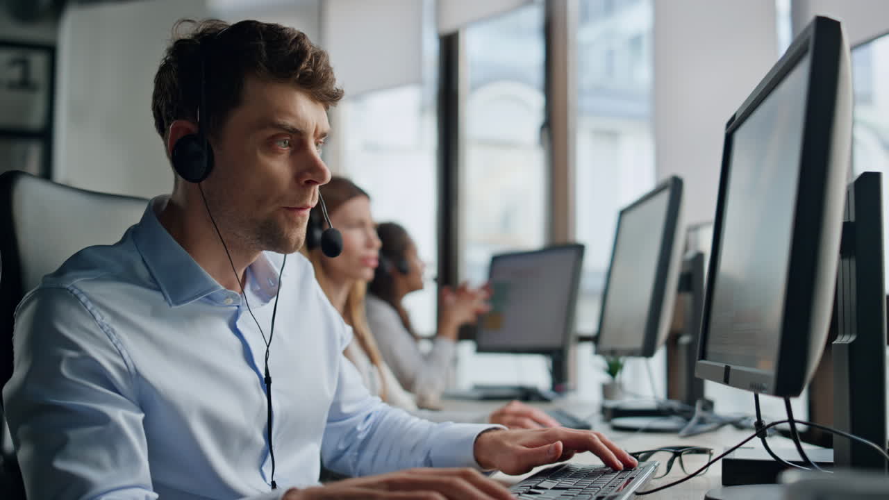 Helpful agent working customer support office. Serious man professional talking