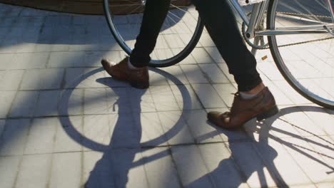 man with bicycle walking on pavement 4k