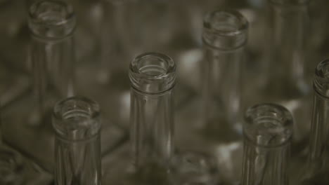 close up panning shot of glass liquor bottle necks