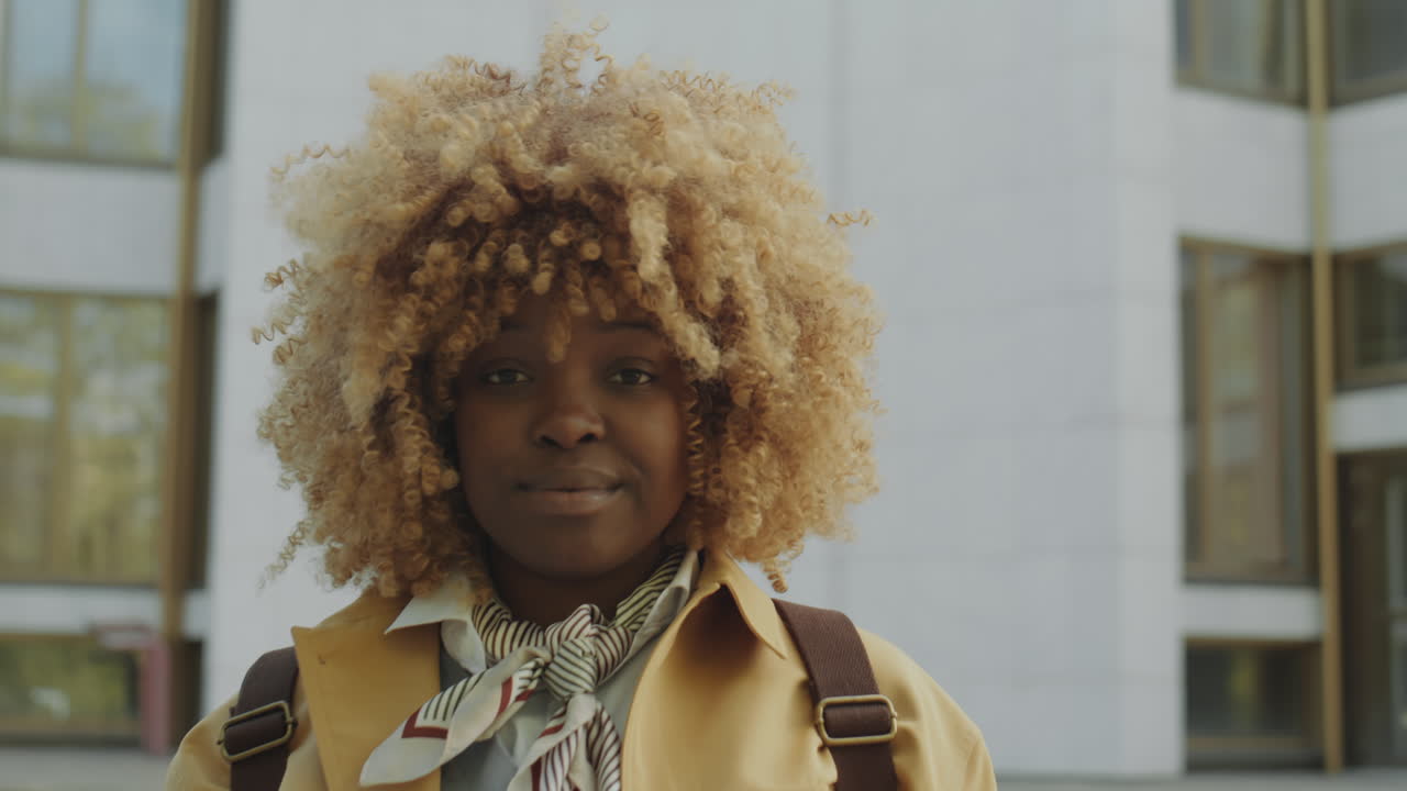 Portrait of a Smiling Young Woman with Curly Blonde Hair