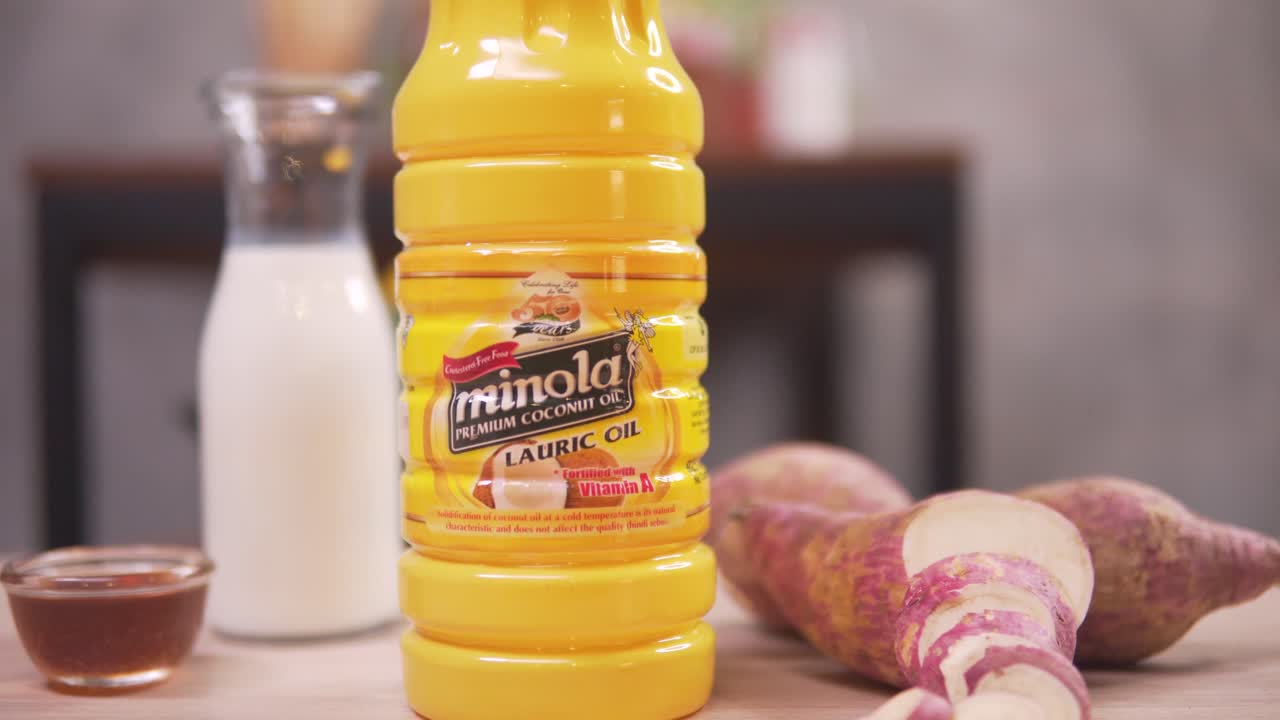 Philippines - A Lauric Oil In A Bottle, Sweet Potatoes, White Vinegar And Fish Sauce, Preparing Ingredients For Cooking - Close Up Pull Shot