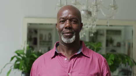 happy african american senior man looking at camera at home