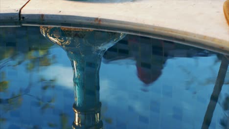 man smokes hookah on the edge of the pool