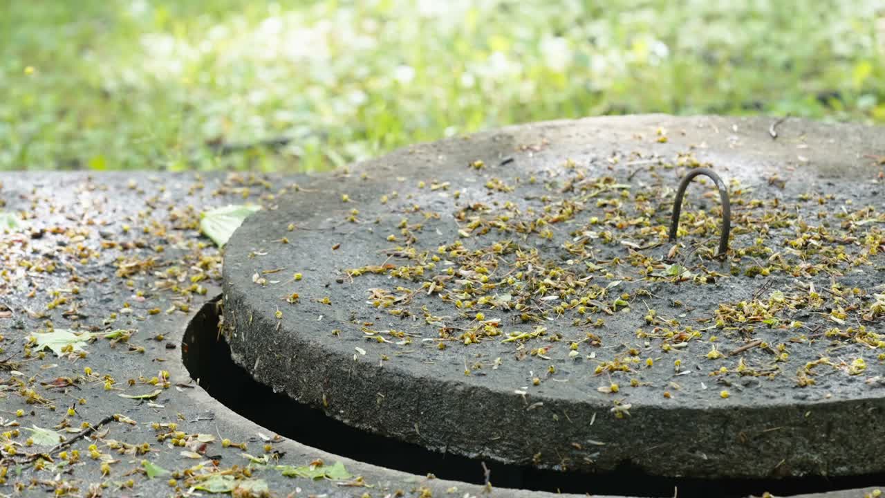 The concrete lid of the manhole on the ground in Estonia