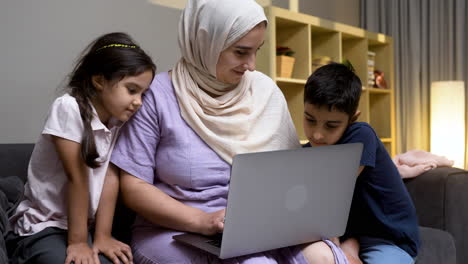 mother, daughter and son in the living room at home