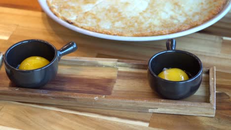 korean pizza with egg yolks on the side served in a restaurant in chuncheon-si, south korea - close up