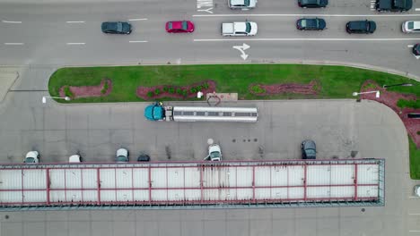 Tanker-semi-truck-driver-offloading-fuel-safely-at-gas-station