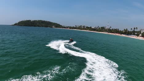 Aerial-tracking-shot-of-unrecognizable-person-on-jet-ski,-Sri-Lanka-coast