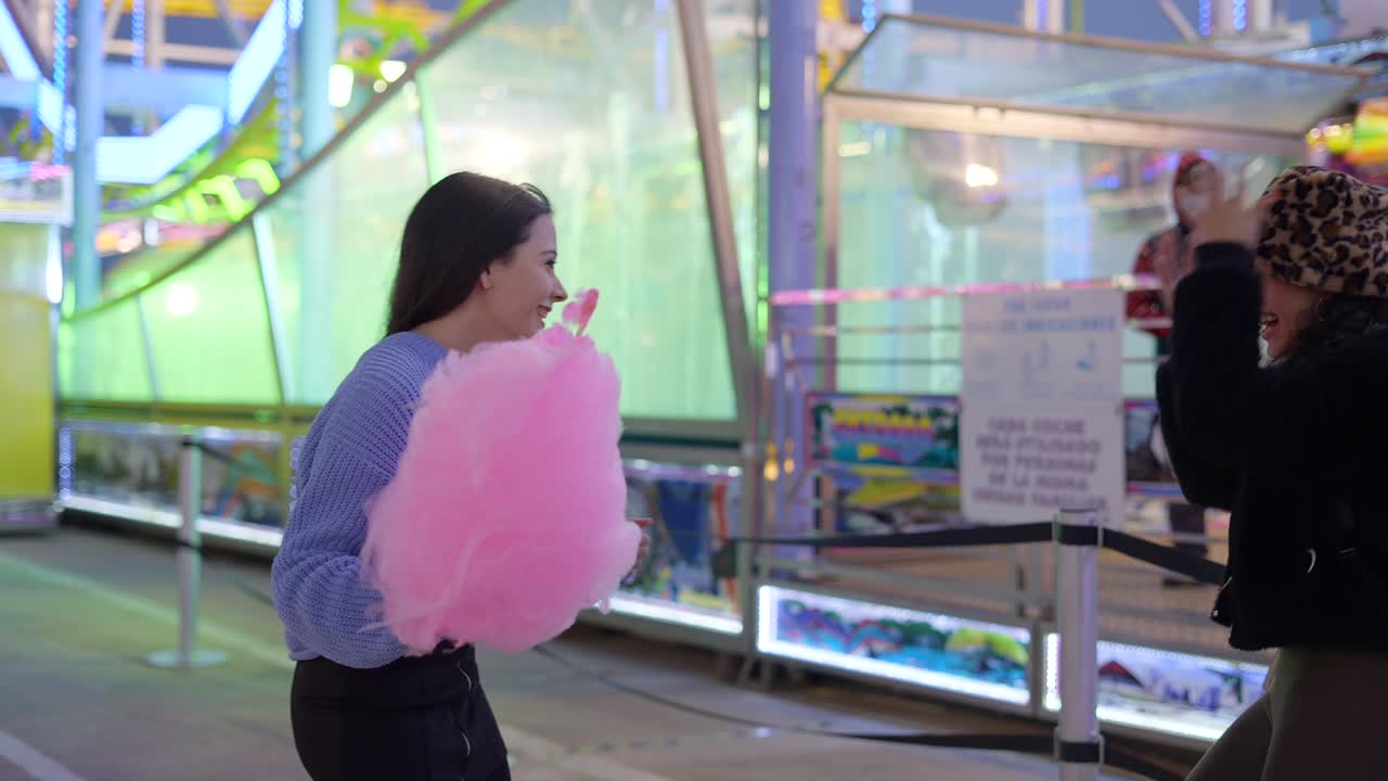 Happy Friends Enjoying Cotton Candy at Amusement Park