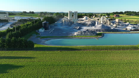 aerial truck shot of limestone quarry among green rural farmland