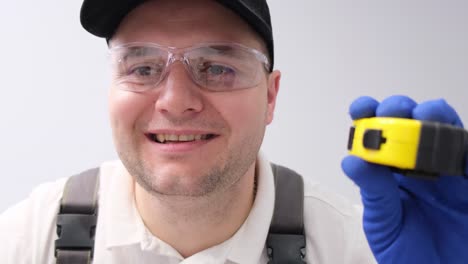 portrait of a man holding a measuring tape on a white background portrait of a man holding a measuring tape on a white background professional furniture installer video