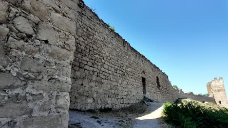 Walking-along-the-stone-walls-of-the-Genoese-Fortress-in-Feodosia,-Crimea