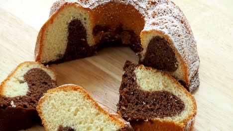 traditional homemade marble cake. sliced marble bundt cake on wooden table