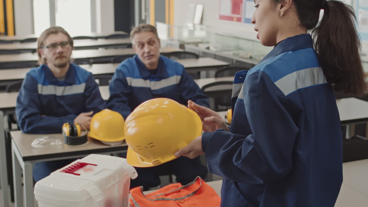 Supervisor Explaining Necessity Of Hard Hats Usage At Workstation