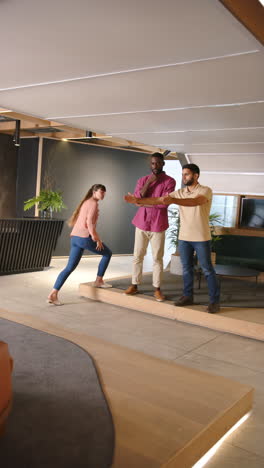 vertical video: discussing project details, diverse colleagues collaborating in modern office space