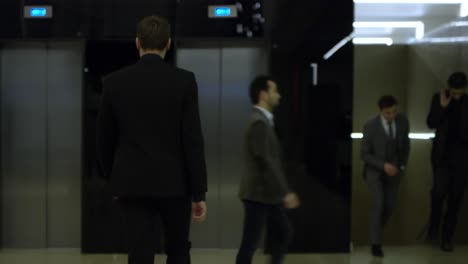 man entering elevator in modern building