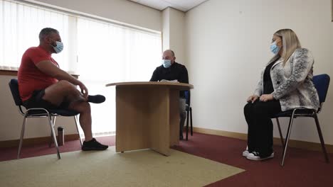 3 people meeting maintaining social distance and wearing face masks