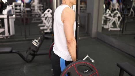 man doing weightlifting in a gym