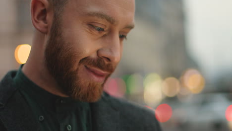 Close-up-view-of-Caucasian-young-man-holding-his-smartphone,-typing-and-texting-on-it-in-the-street