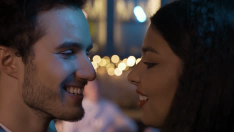 close up view of a couple celebrating new year's eve party, they get closer and kiss while smiling 3