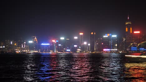 reflejos de neón de las luces de la ciudad brillan en la superficie del agua, pequeño barco
